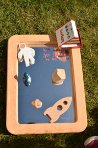 Mirror with wooden space themed toys and a 6 pack of kitpas crayons