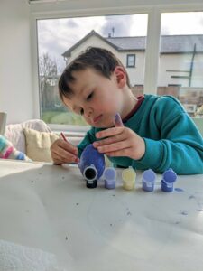 Little Ones: wooden egg being painted